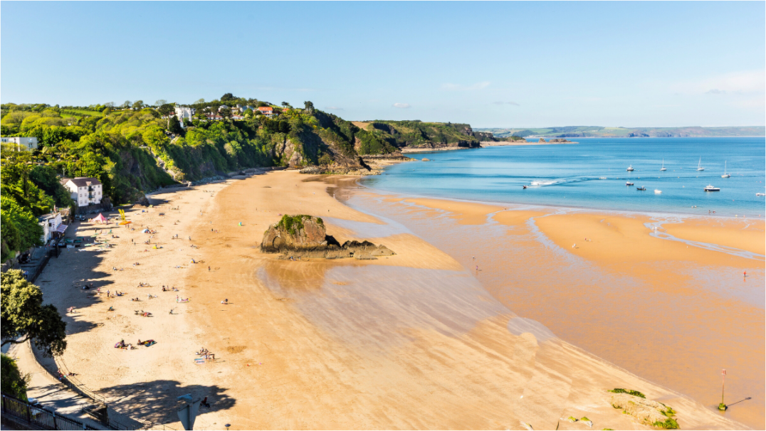 Tenby Beach, the tide is out showing dry and wet sand