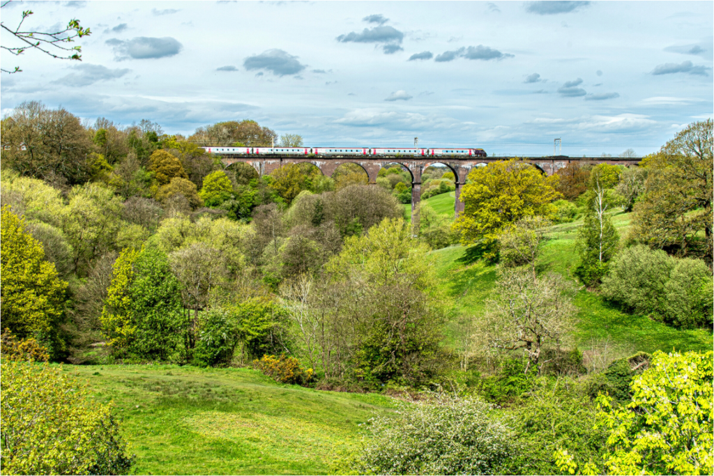 Railway Viaduct over River Dane with train passing over